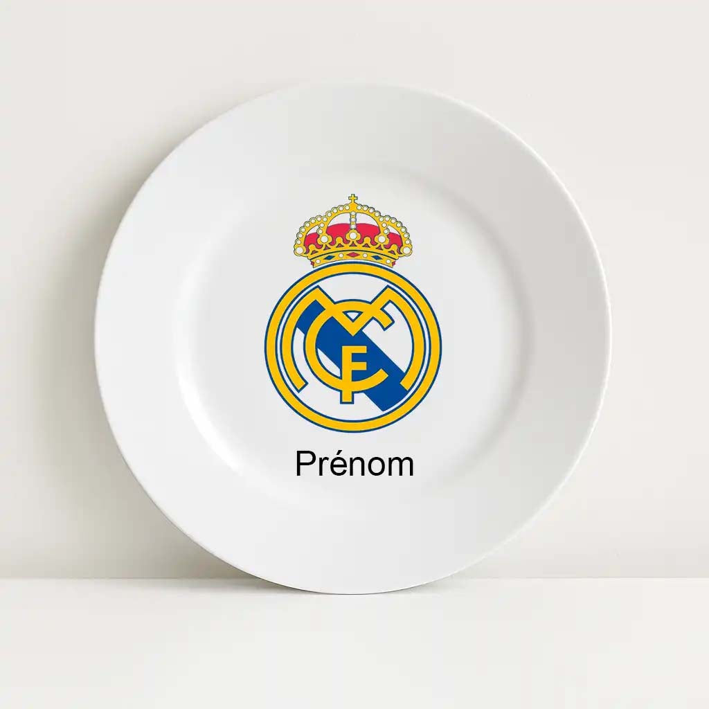 Assiette blanche incassable avec le logo du club de football Real Madrid imprimé au centre, accompagnée du mot "Prénom" en dessous, pour personnalisation.