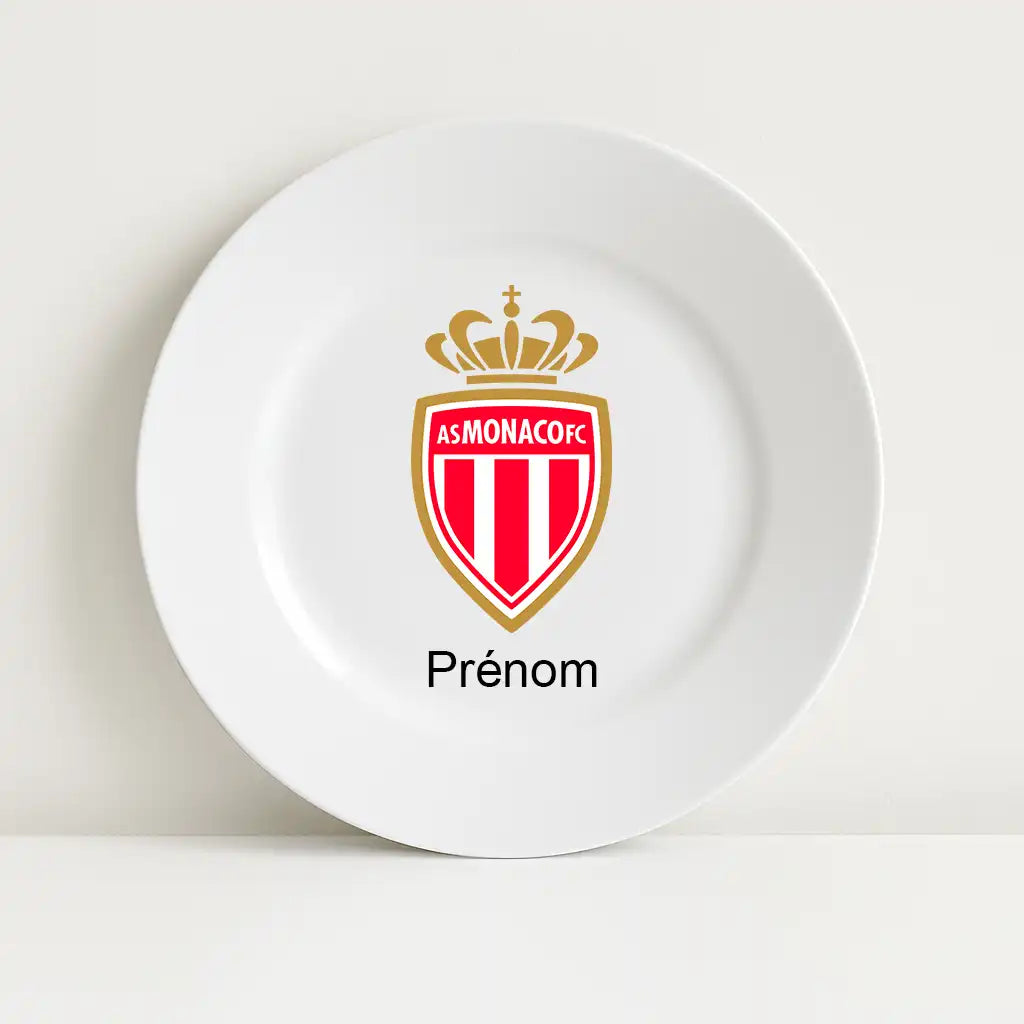Assiette blanche avec le logo du club de football AS Monaco au centre, surmontant l’inscription personnalisable "Prénom".