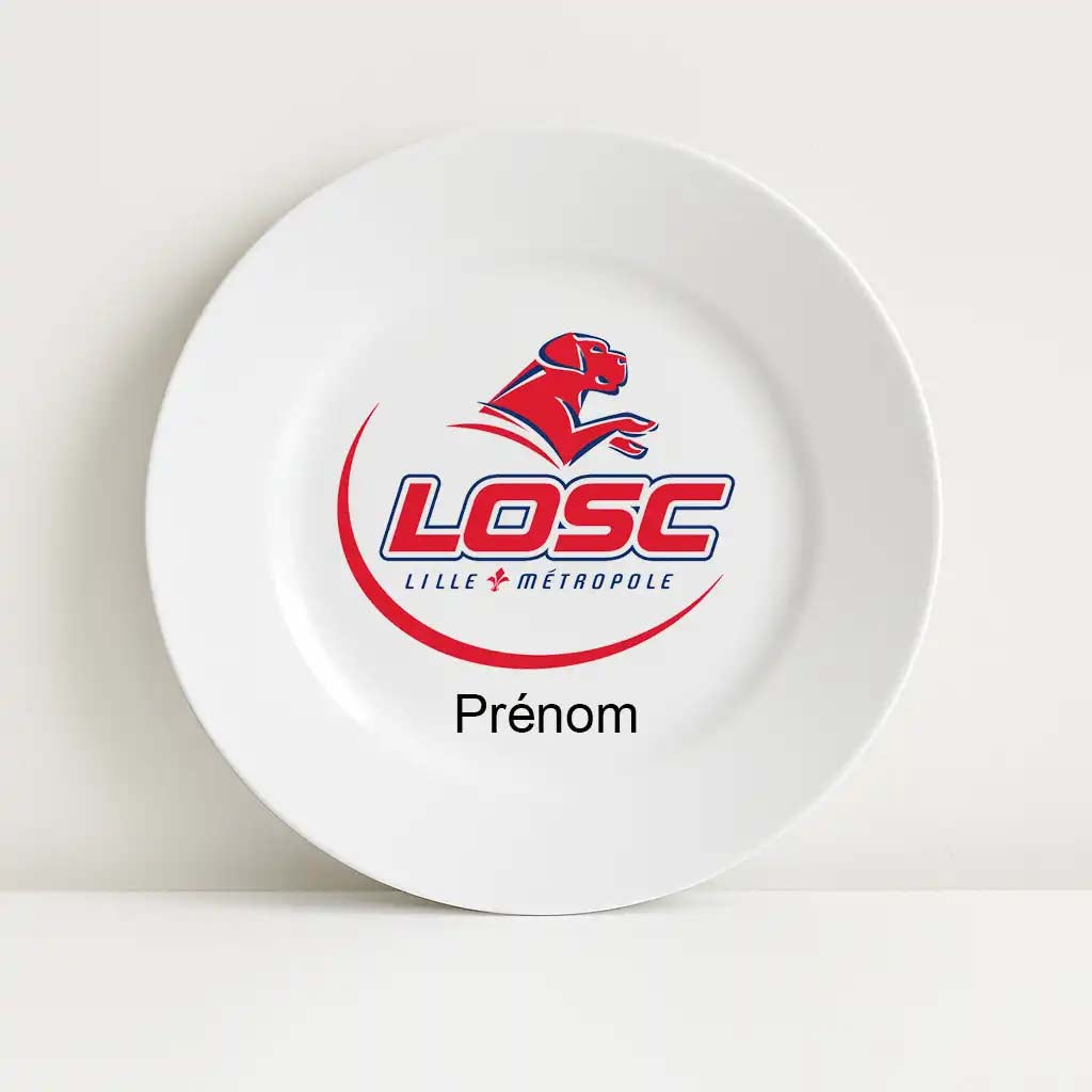 Assiette blanche incassable ornée du logo du LOSC Lille Métropole, avec un chien stylisé rouge en mouvement au-dessus de l’inscription "LOSC". Le mot "Prénom" figure en dessous pour une personnalisation individuelle.