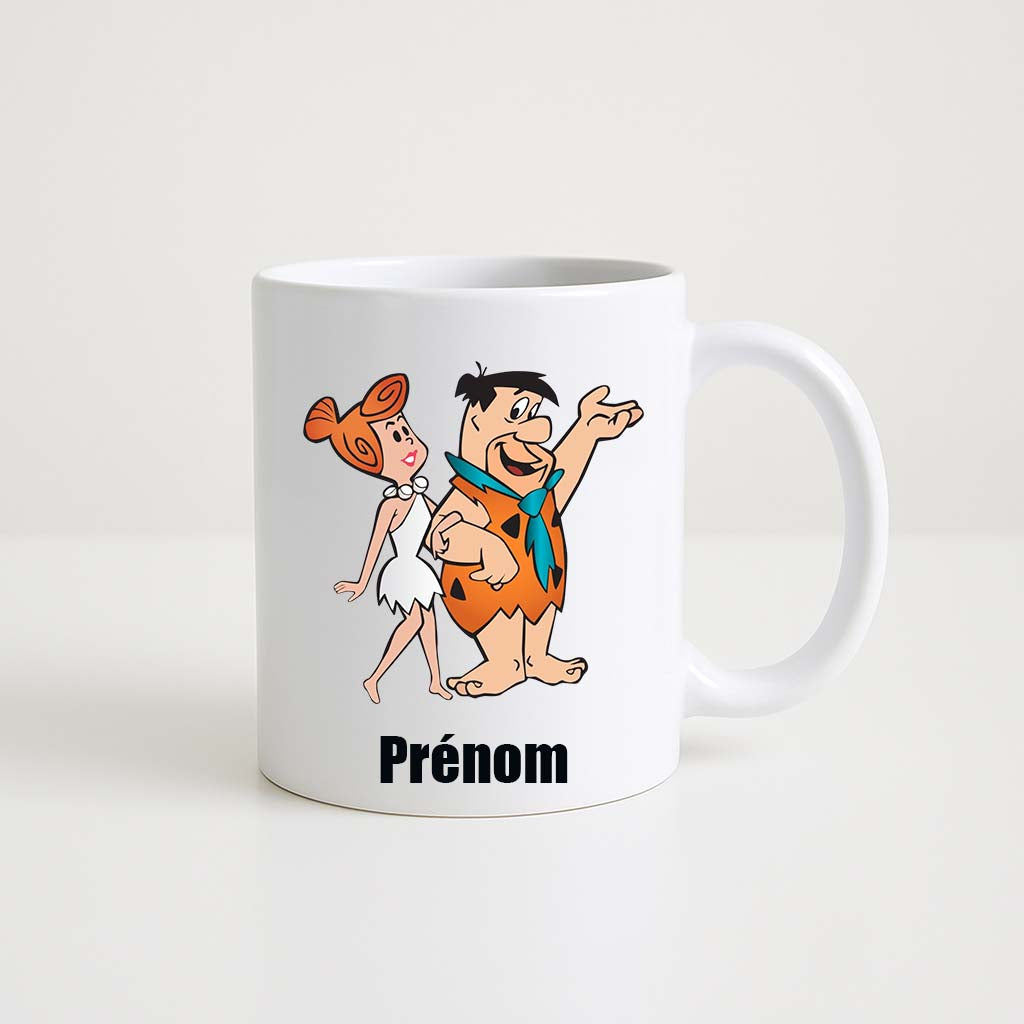 Mug blanc 330ml avec Fred Pierrafeu, Wilma et Dino, espace pour un prénom personnalisable.