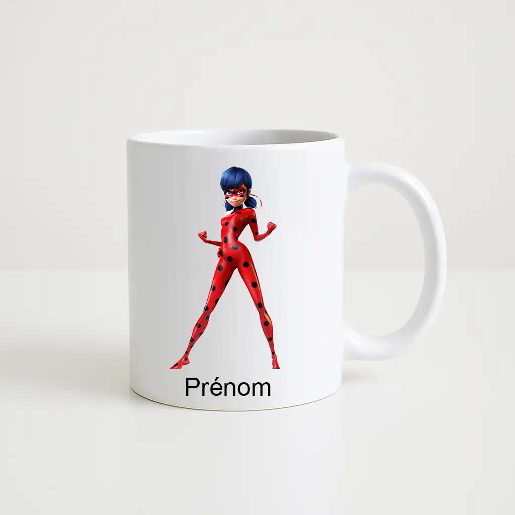 Mug blanc en céramique avec illustration de Ladybug (Miraculous) en position héroïque bras levés, costume rouge à pois noirs, avec espace personnalisable pour prénom