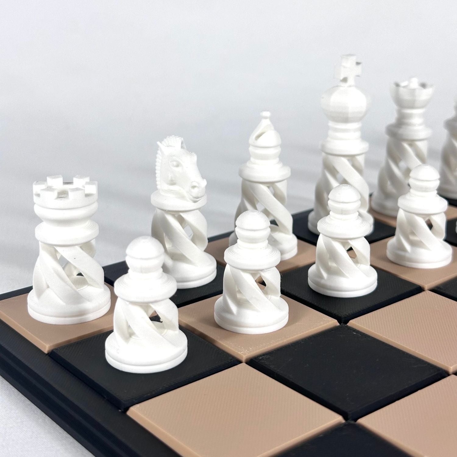 Pièces d’échecs modernes spiralées couleur blanche sur échiquier beige et noir, impression 3D.